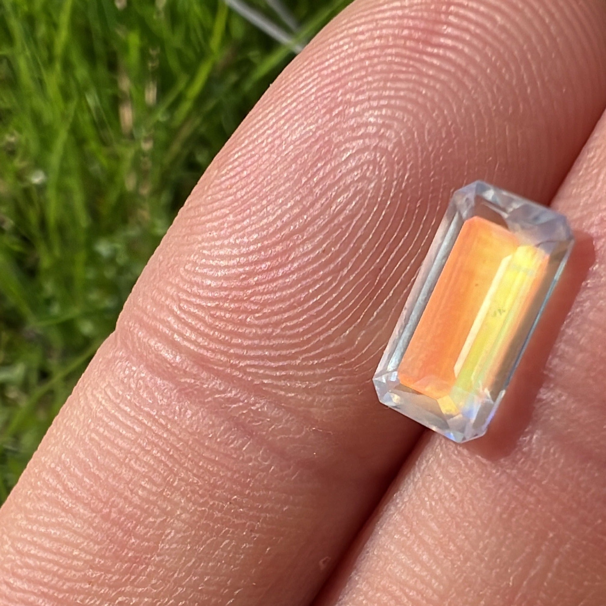 The rainbow moonstone showing it warmer colors in the natural light