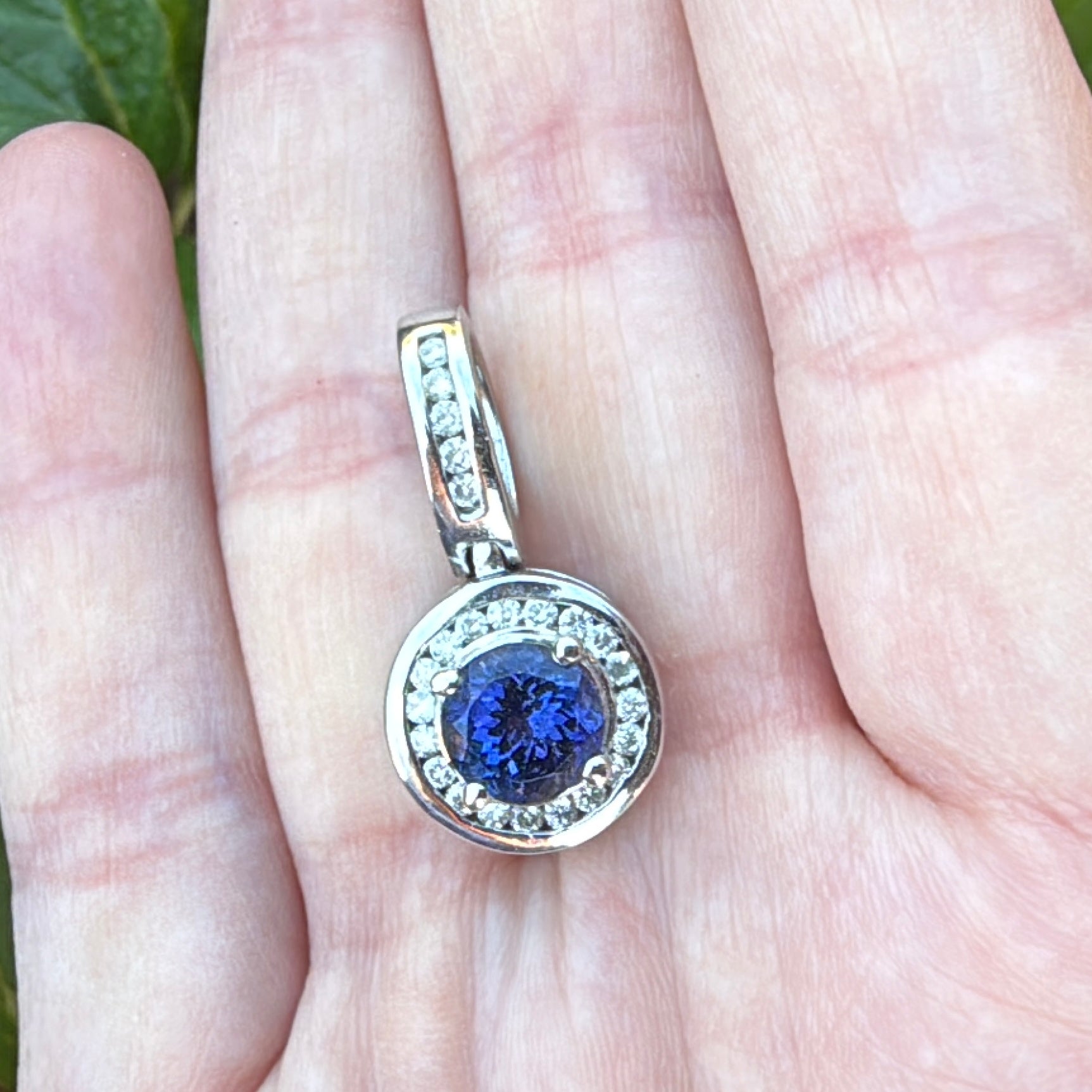 Tanzanite white gold pendant with diamonds and large bail in hand