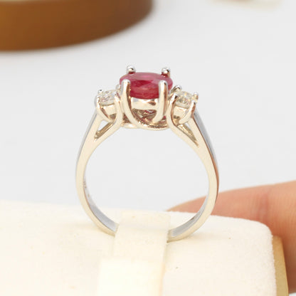 Three stone ruby ring with side diamonds set in white gold classic design