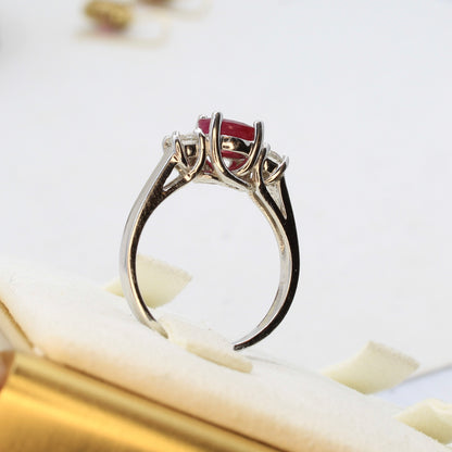 Three stone ruby ring with side diamonds set in white gold classic design