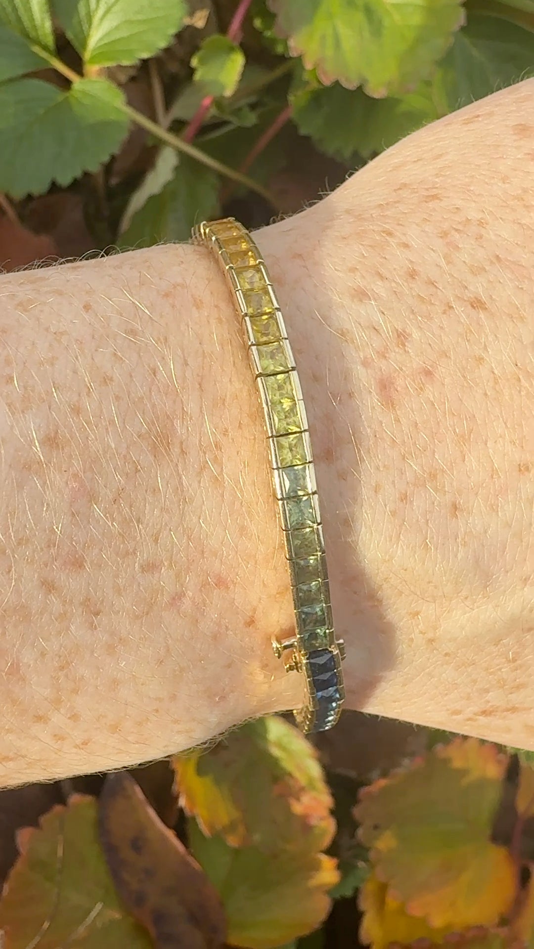 Rainbow sapphire deco style bracelet 14K yellow gold on wrist in natural light