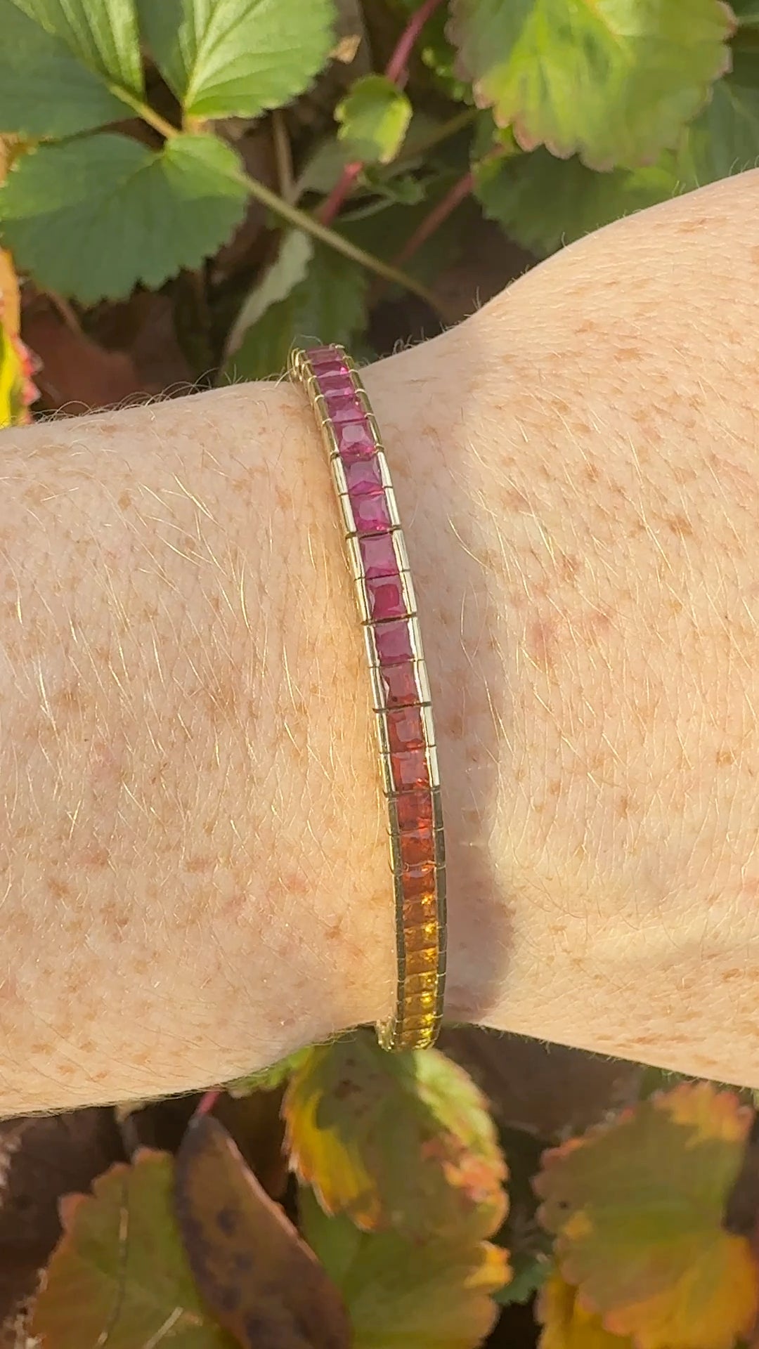 Rainbow sapphire deco style bracelet 14K yellow gold on wrist in natural light