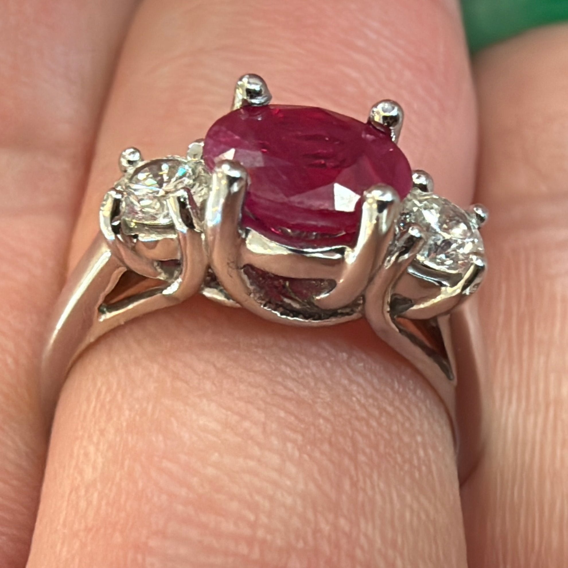 side view of ruby and diamond three stone ring set in white gold