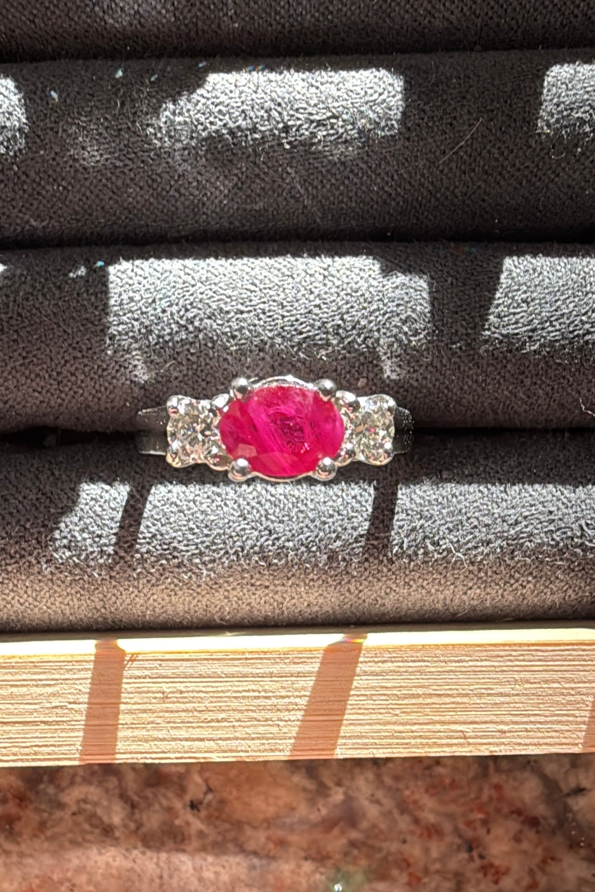 three stone ruby ring set in white gold with 2 round diamond side stones