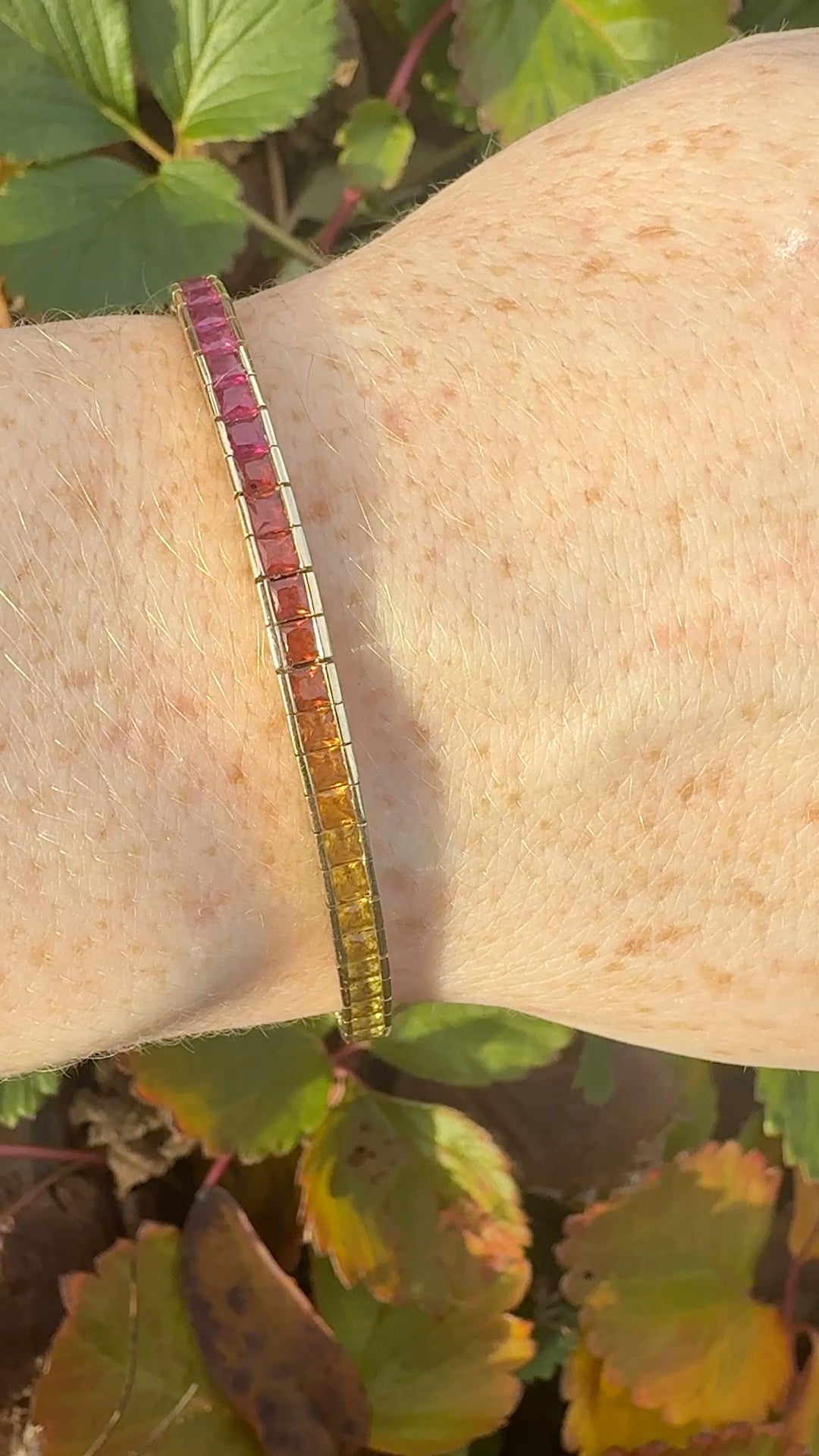 Rainbow sapphire deco style bracelet 14K yellow gold on wrist in natural light