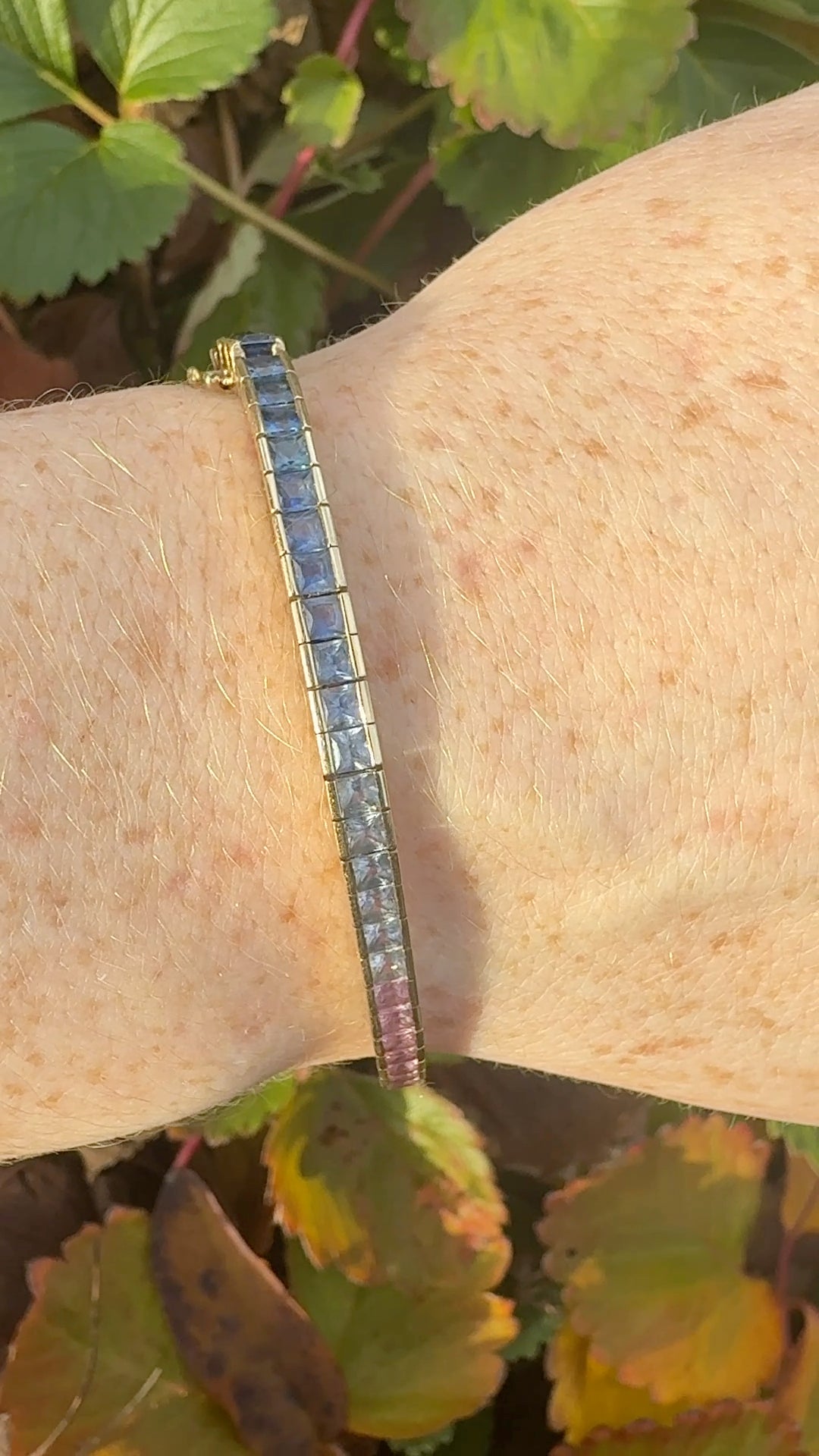 Rainbow sapphire deco style bracelet 14K yellow gold on wrist in natural light