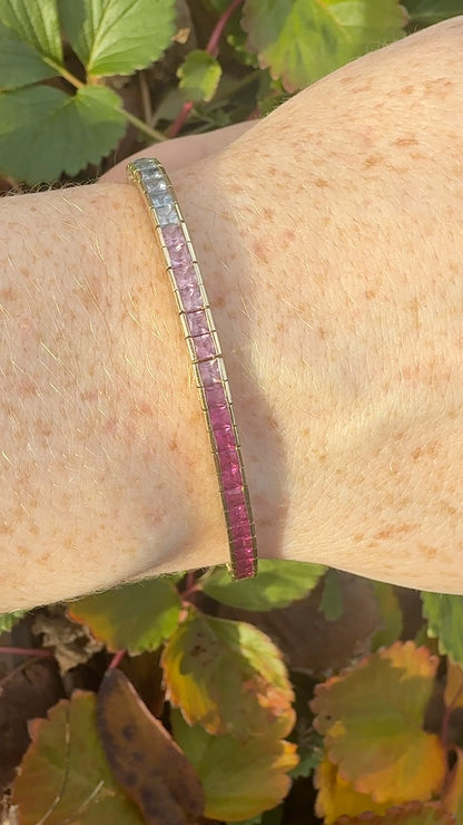 Rainbow sapphire deco style bracelet 14K yellow gold on wrist in natural light