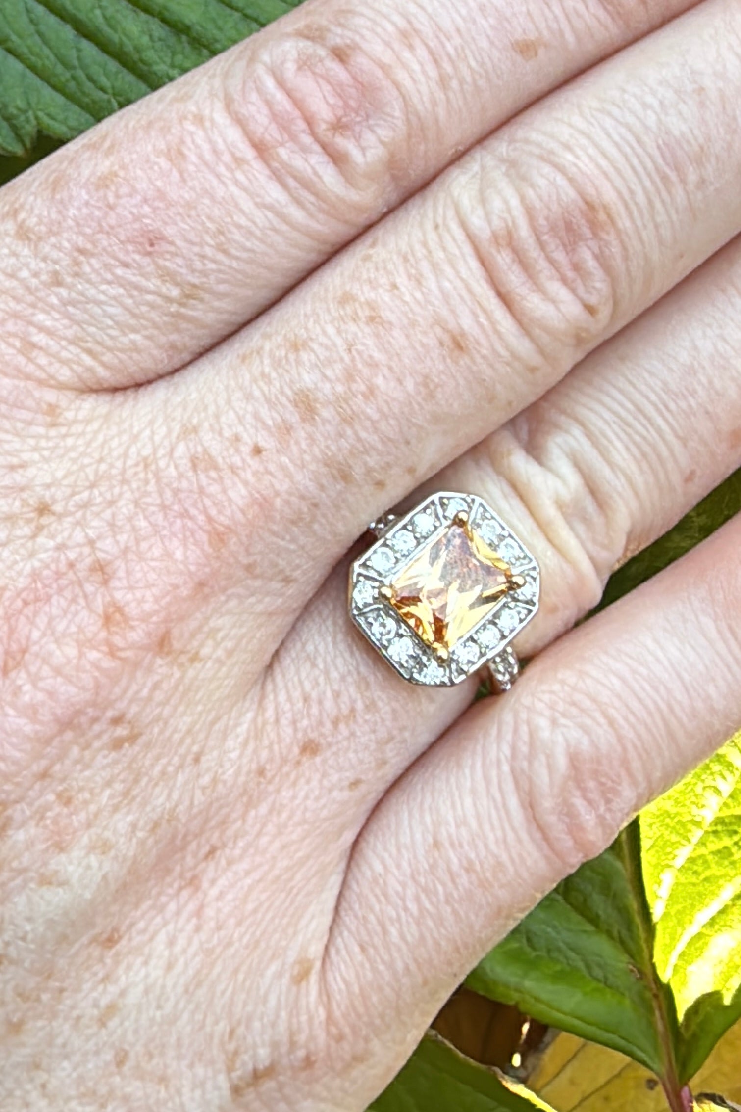 imperial topaz diamond and gold ring on hand ring finger