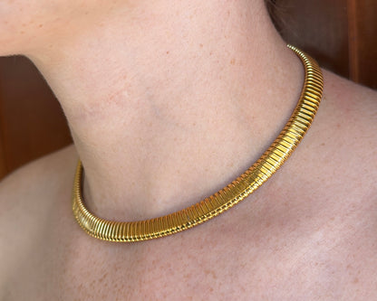 Tubogas necklace in 18k yellow gold on a neck