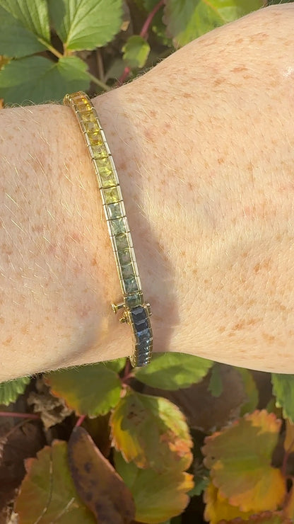 Rainbow sapphire deco style bracelet 14K yellow gold on wrist in natural light