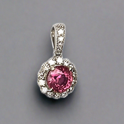 Pink sapphire pendant with a halo of diamonds, tilted to the side