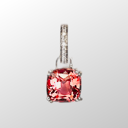 Close up of the pink tourmaline pendant with a light gray background