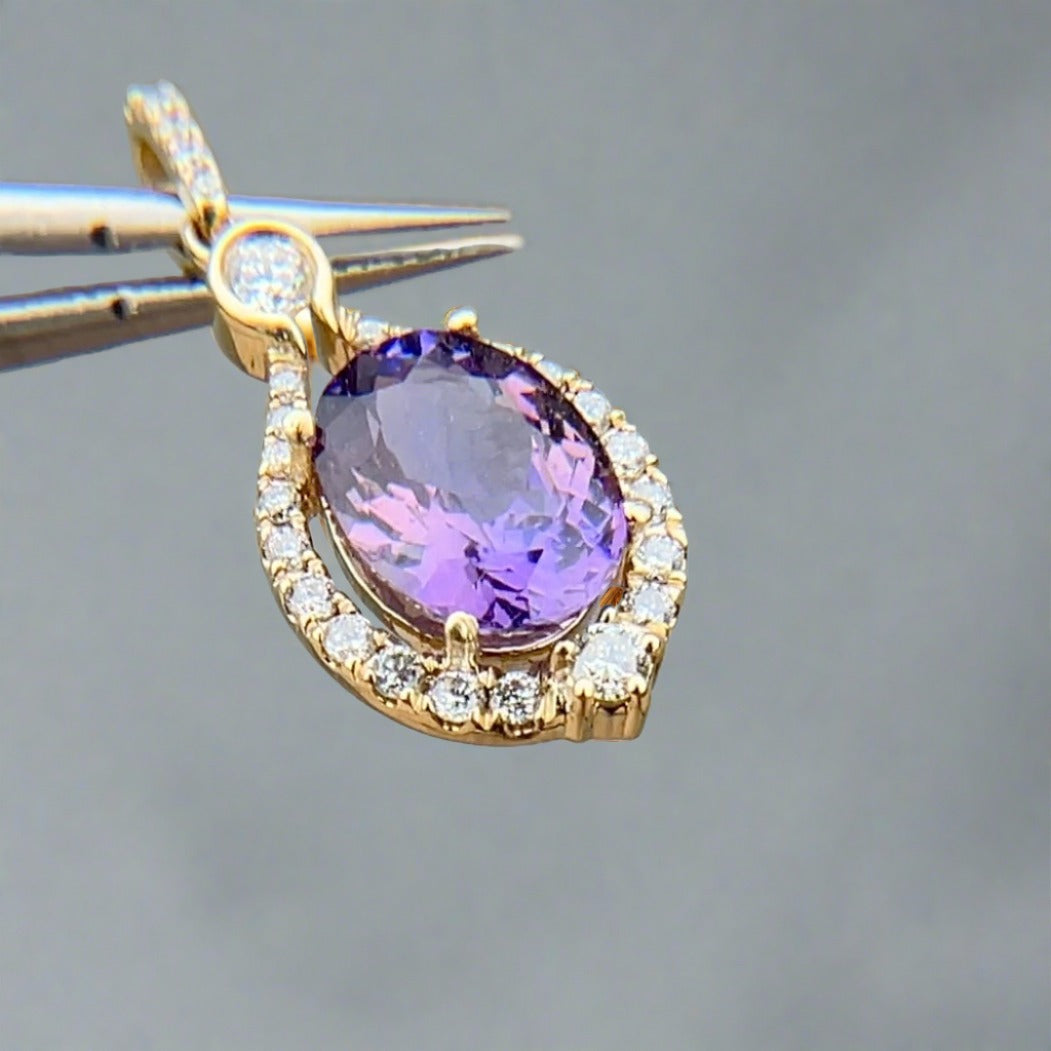 Fancy pink purple tanzanite in 14k yellow gold with diamond halo and tilted to the side