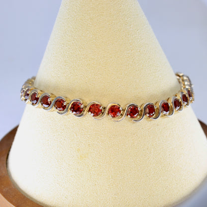 garnet sterling silver tennis bracelet on a display stand