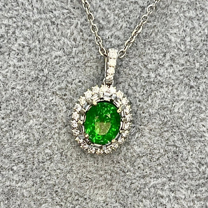 The halo pendant oval tsavorite on a chain with a felt background.