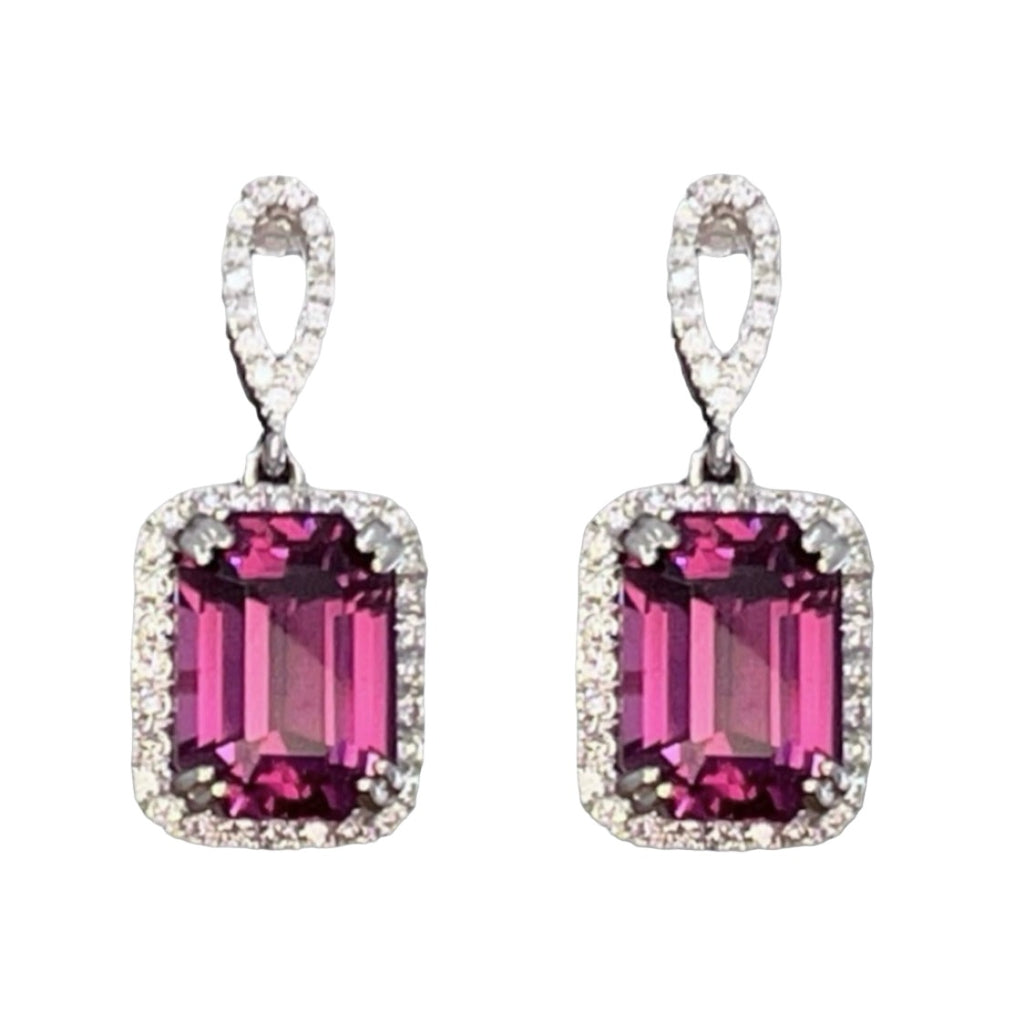 A pair of mahenge purplish pink garnet drop earrings with a halo of diamonds and a grey background