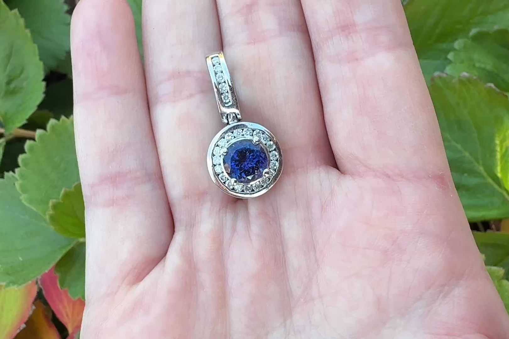 Tanzanite white gold pendant with diamonds and large bail in hand