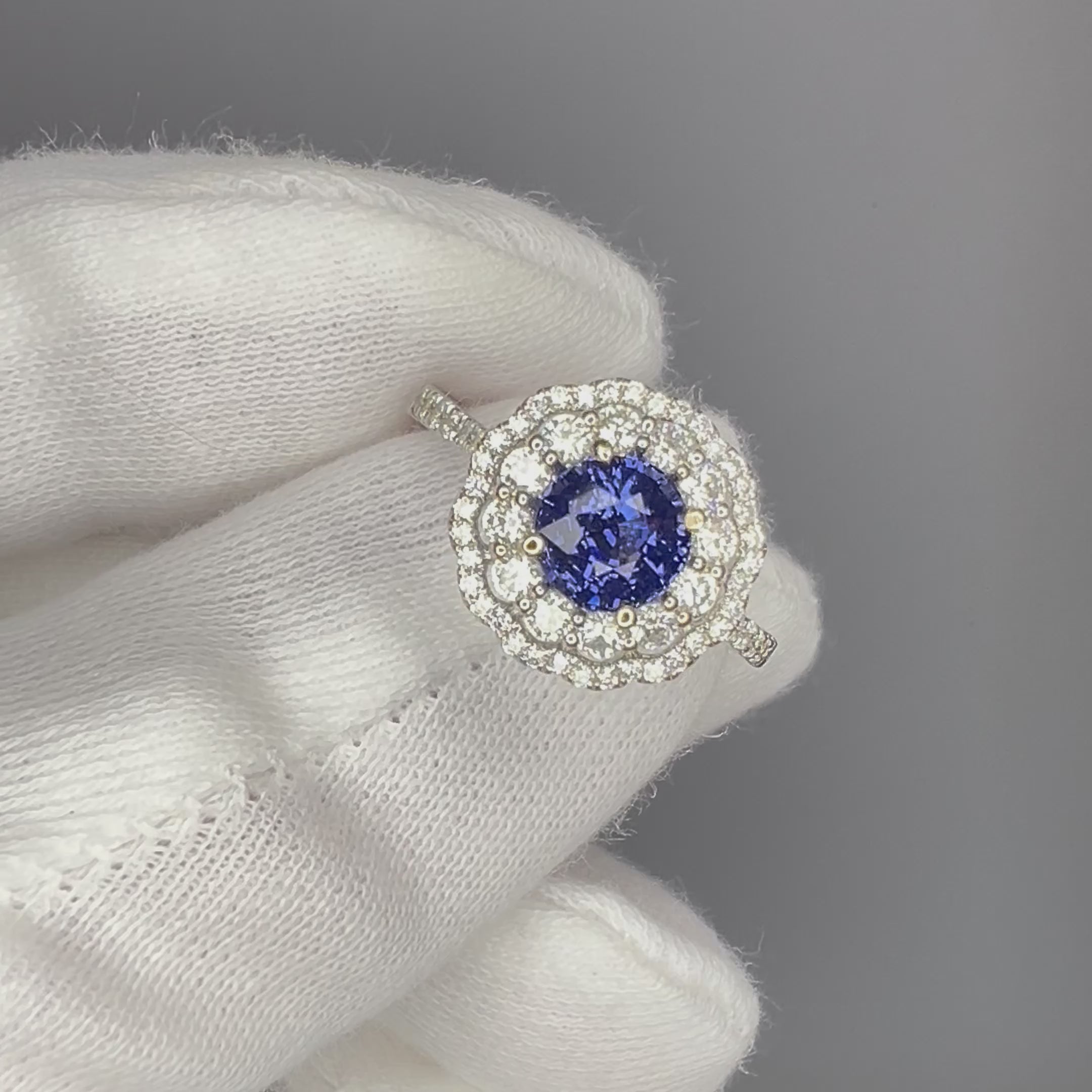 Blue Spinel Engagement Ring in white gold held by white glove