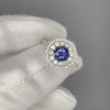Blue Spinel Engagement Ring in white gold held by white glove