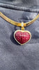 invisible set ruby heart pendant with a latching clasp and diamond accent.